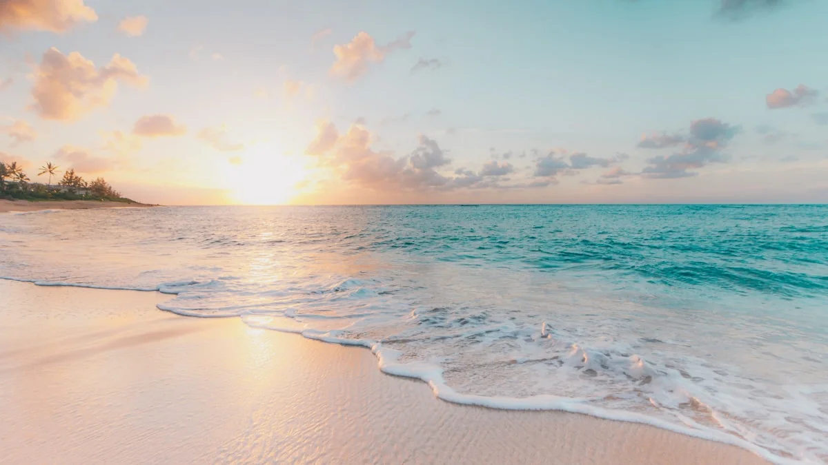 Gentle waves reaching a quiet beach at sunset