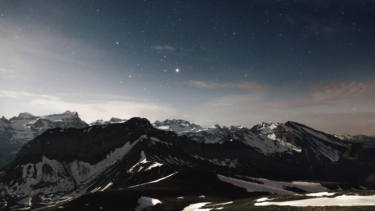 A mountain range under a clear starry night sky